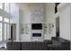 Open-concept living room with fireplace, TV, built-ins, and high ceilings at 337 Lakeshore Dr, Berkeley Lake, GA 30096