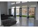 Spacious living room with floor to ceiling windows and glass doors leading to outdoor area at 337 Lakeshore Dr, Berkeley Lake, GA 30096