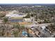 Expansive aerial view of the property showcasing its location with nearby schools, tree coverage and neighborhood streets at 1444 Norman Berry Dr, East Point, GA 30344