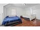 Upstairs bedroom with wood floors, twin beds, and natural lighting at 1444 Norman Berry Dr, East Point, GA 30344