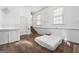 Minimalist bedroom with wood floors, stairs, and ample natural light at 1444 Norman Berry Dr, East Point, GA 30344