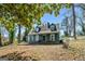 Charming two-story home with a covered front porch and dormer windows nestled under mature trees at 1444 Norman Berry Dr, East Point, GA 30344