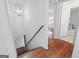 Hallway with hardwood floors and simple chandelier at 1444 Norman Berry Dr, East Point, GA 30344