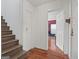 Hallway featuring wooden floors, stairs, neutral walls and access to other rooms at 1444 Norman Berry Dr, East Point, GA 30344
