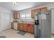 Functional kitchen featuring stainless steel appliances, wood cabinetry, and tile floors at 1444 Norman Berry Dr, East Point, GA 30344
