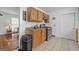 Compact kitchen with wood cabinets, tile floors, and essential appliances at 1444 Norman Berry Dr, East Point, GA 30344