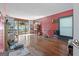 Large, open living room with built-in bookshelves, hardwood floors, and access to the outside patio at 1444 Norman Berry Dr, East Point, GA 30344