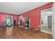 Spacious living room featuring hardwood floors, a fireplace, and ample natural light streaming through a window at 1444 Norman Berry Dr, East Point, GA 30344
