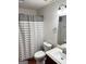 Well-lit bathroom with a neutral palette featuring a standard toilet and a full mirror above the sink at 555 Windchase Ln, Stone Mountain, GA 30083