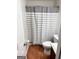 Cozy bathroom featuring a shower-tub combination with a striped curtain at 555 Windchase Ln, Stone Mountain, GA 30083