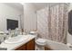 Cozy bathroom featuring a shower-tub combination with a leaf patterned curtain at 555 Windchase Ln, Stone Mountain, GA 30083