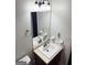 Compact bathroom featuring a pedestal sink, a toilet, and a classic mirror at 555 Windchase Ln, Stone Mountain, GA 30083