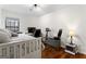 Bedroom featuring hardwood floors, a ceiling fan, a work space, and an exercise bike at 555 Windchase Ln, Stone Mountain, GA 30083