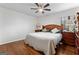 A bright bedroom featuring hardwood floors, a ceiling fan, and a large window for natural light at 555 Windchase Ln, Stone Mountain, GA 30083