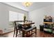 Bright dining room with modern light fixture and seating for six at 555 Windchase Ln, Stone Mountain, GA 30083