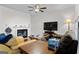 Bright living room with a fireplace and modern ceiling fan at 555 Windchase Ln, Stone Mountain, GA 30083