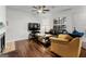 Comfortable living room with hardwood floors, a fireplace, and plenty of natural light at 555 Windchase Ln, Stone Mountain, GA 30083