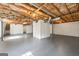 Spacious unfinished basement with utilities, painted floors and exposed ceiling rafters at 256 Butterworth Rd, Canton, GA 30114
