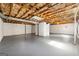 Unfinished basement with exposed ceiling, painted concrete floor and white concrete walls at 256 Butterworth Rd, Canton, GA 30114