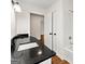Bathroom featuring a white shower and tub combination and a vanity with black countertop at 256 Butterworth Rd, Canton, GA 30114