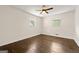 Bedroom featuring wood floors, a ceiling fan and two windows bringing in natural light at 256 Butterworth Rd, Canton, GA 30114