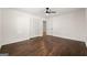 Bedroom with wood floors, a ceiling fan, closet, and a view into the hallway at 256 Butterworth Rd, Canton, GA 30114