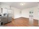 Kitchen and dining area with stainless steel refrigerator and wood-look floors at 256 Butterworth Rd, Canton, GA 30114
