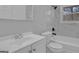 Stylish bathroom featuring white fixtures, marble tile, and modern fixtures at 3047 Horse Shoe Se Dr, Atlanta, GA 30316