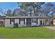 Charming single-story home with fresh, white paint, black trim, and a well-manicured front lawn at 3047 Horse Shoe Se Dr, Atlanta, GA 30316