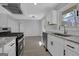 Spacious modern kitchen features granite counters, stainless appliances, and hardwood floors at 3047 Horse Shoe Se Dr, Atlanta, GA 30316
