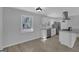 Clean kitchen featuring white cabinetry, stainless steel appliances, hardwood floors and lots of natural light at 3047 Horse Shoe Se Dr, Atlanta, GA 30316