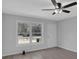Inviting living room with wood-look floors, a large window, neutral colors, and a ceiling fan at 3047 Horse Shoe Se Dr, Atlanta, GA 30316