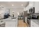 Open kitchen with a granite island, stainless appliances and wood-look floors at 44 Leggit Dr # 179, Villa Rica, GA 30180