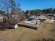 Picture of backyard featuring pool, storage shed and lovely fence surrounding yard on a sunny day at 140 Surrey Park Dr, Fayetteville, GA 30215
