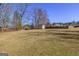 Expansive backyard with shed and a backdrop of trees. A fenced perimeter offers privacy at 140 Surrey Park Dr, Fayetteville, GA 30215