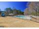 Large backyard features a fenced-in in-ground pool and playground equipment at 140 Surrey Park Dr, Fayetteville, GA 30215