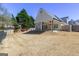 Backyard view with patio and well-maintained lawn at 140 Surrey Park Dr, Fayetteville, GA 30215