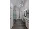 Bathroom featuring and vanities, granite counters, decorative lighting, and modern shower at 140 Surrey Park Dr, Fayetteville, GA 30215