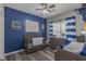 Stylishly decorated bedroom with blue accents and hardwood floors at 140 Surrey Park Dr, Fayetteville, GA 30215