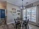 Dining area with round wood table and chairs adjacent to the kitchen and near a window at 140 Surrey Park Dr, Fayetteville, GA 30215