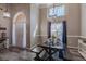 Dining room with a dark wood table set for a meal, complemented by stylish lighting and curtains at 140 Surrey Park Dr, Fayetteville, GA 30215