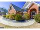 Charming brick home with well-manicured landscaping and a stone walkway, offering a welcoming approach at 140 Surrey Park Dr, Fayetteville, GA 30215