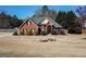 Beautiful brick home featuring a well-manicured lawn, complemented by dark shutters and a charming walkway at 140 Surrey Park Dr, Fayetteville, GA 30215