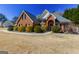 Beautiful brick home with manicured shrubs and a charming arched entryway, offering classic curb appeal at 140 Surrey Park Dr, Fayetteville, GA 30215