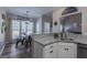 Bright kitchen with white cabinets, granite countertops, and view into the dining area at 140 Surrey Park Dr, Fayetteville, GA 30215
