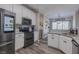 Updated kitchen featuring granite countertops, stainless steel appliances, and white cabinets at 140 Surrey Park Dr, Fayetteville, GA 30215