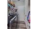 Laundry room with stainless steel washer and dryer and white cabinets at 140 Surrey Park Dr, Fayetteville, GA 30215