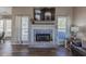 Cozy living room showcasing a fireplace, mantle with decor, and neutral finishes at 140 Surrey Park Dr, Fayetteville, GA 30215