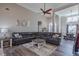 Open-concept living room with a large sectional sofa, neutral colors, and a view of the dining area at 140 Surrey Park Dr, Fayetteville, GA 30215