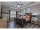 Well decorated main bedroom with trey ceilings, wood floors, and cozy furniture at 140 Surrey Park Dr, Fayetteville, GA 30215